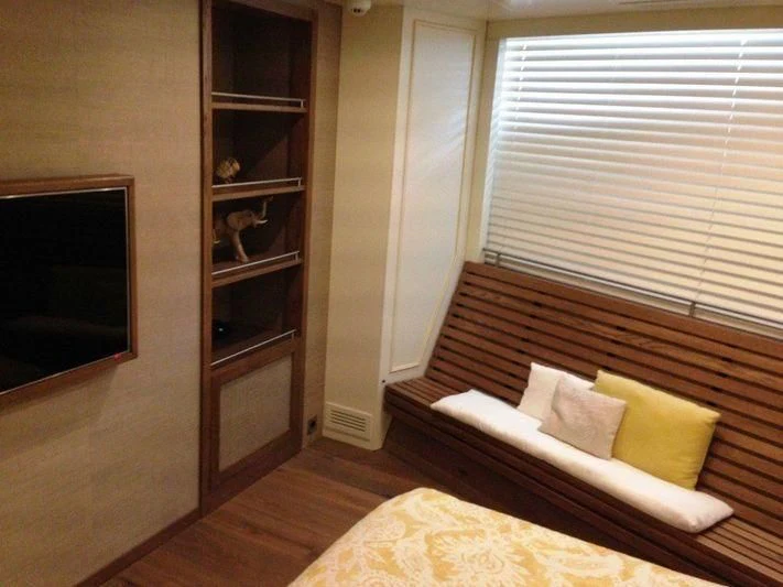 a room with a bed and a shelf with a mirror aboard LUTTEUR Yacht for Sale