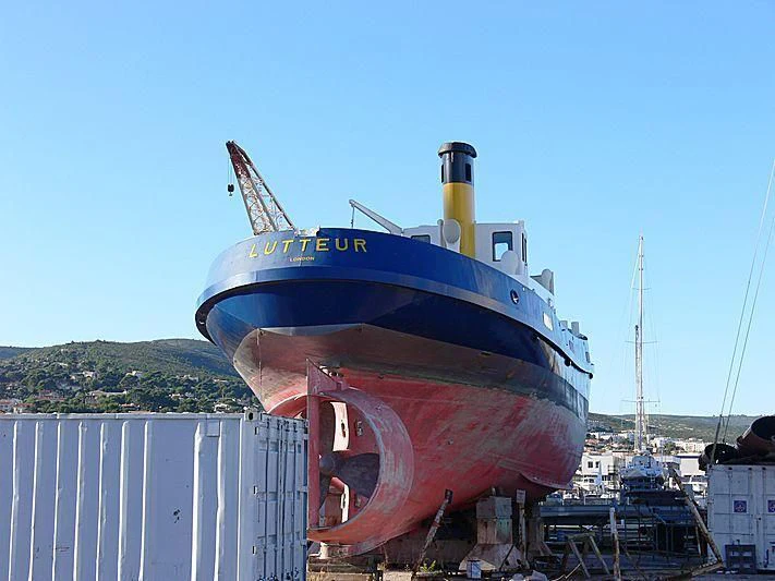 a large blue and red boat docked aboard LUTTEUR Yacht for Sale