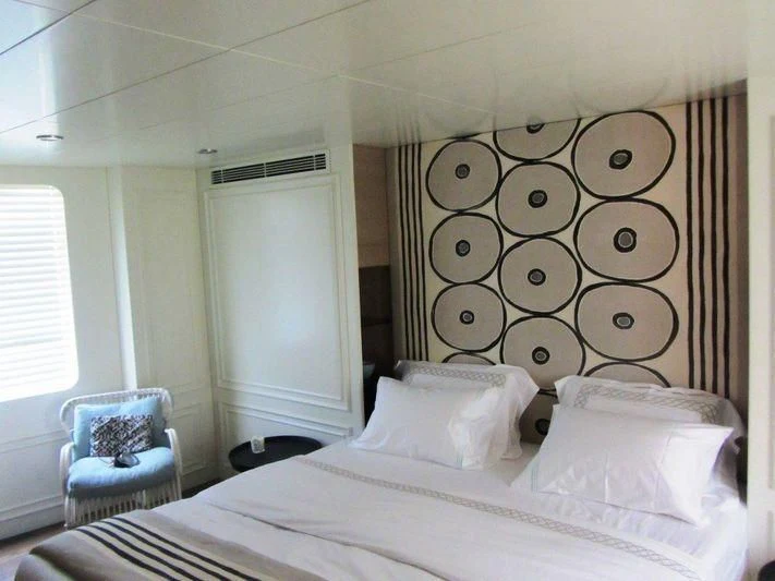 a bed with white sheets and pillows aboard LUTTEUR Yacht for Sale
