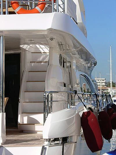 a white boat with red flags aboard RIMA Yacht for Sale