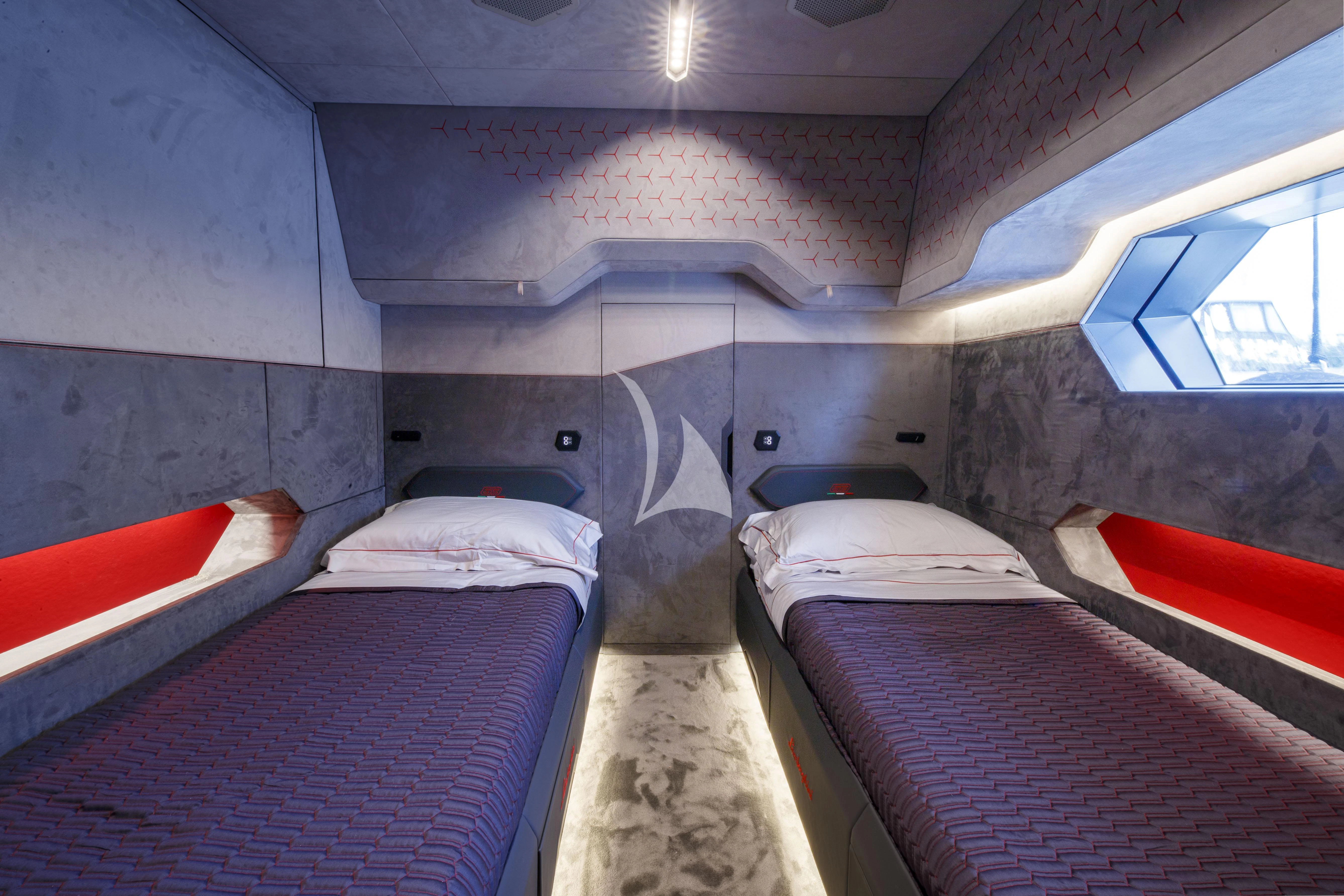 a room with beds and a window aboard FAST ONE Yacht for Charter