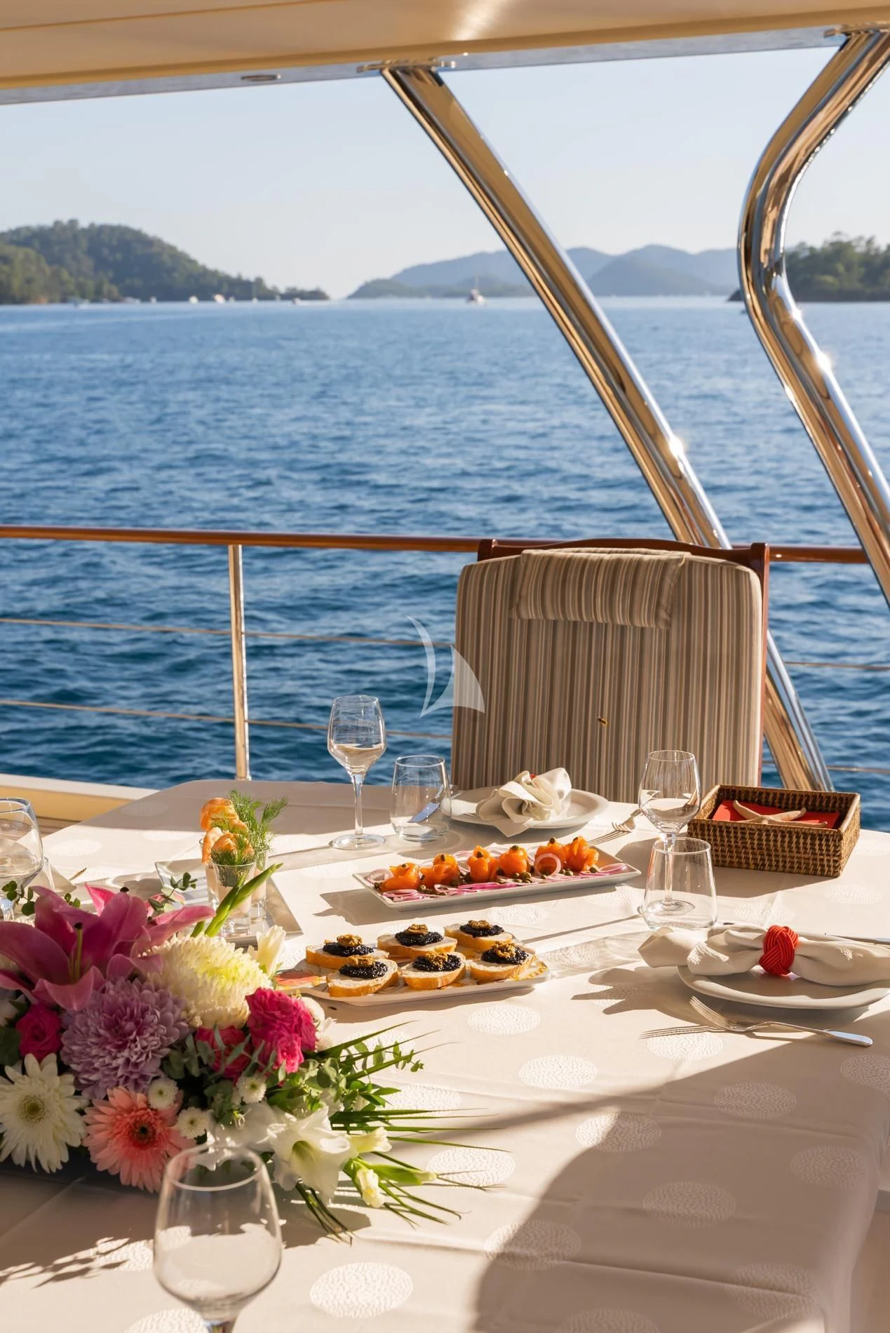 a table with food and wine on it aboard DAIMA Yacht for Sale