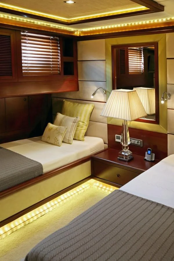 a room with two beds aboard DAIMA Yacht for Sale