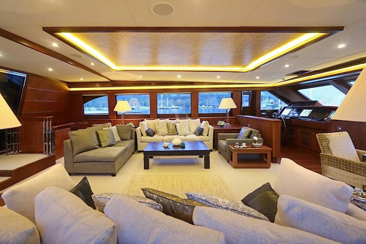 a living room with a large couch and a large window aboard DAIMA Yacht for Sale