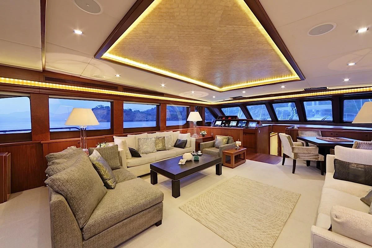 a large living room with a large screen aboard DAIMA Yacht for Sale