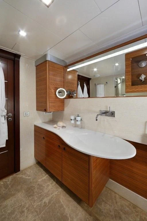 a bathroom with a large mirror aboard DAIMA Yacht for Sale