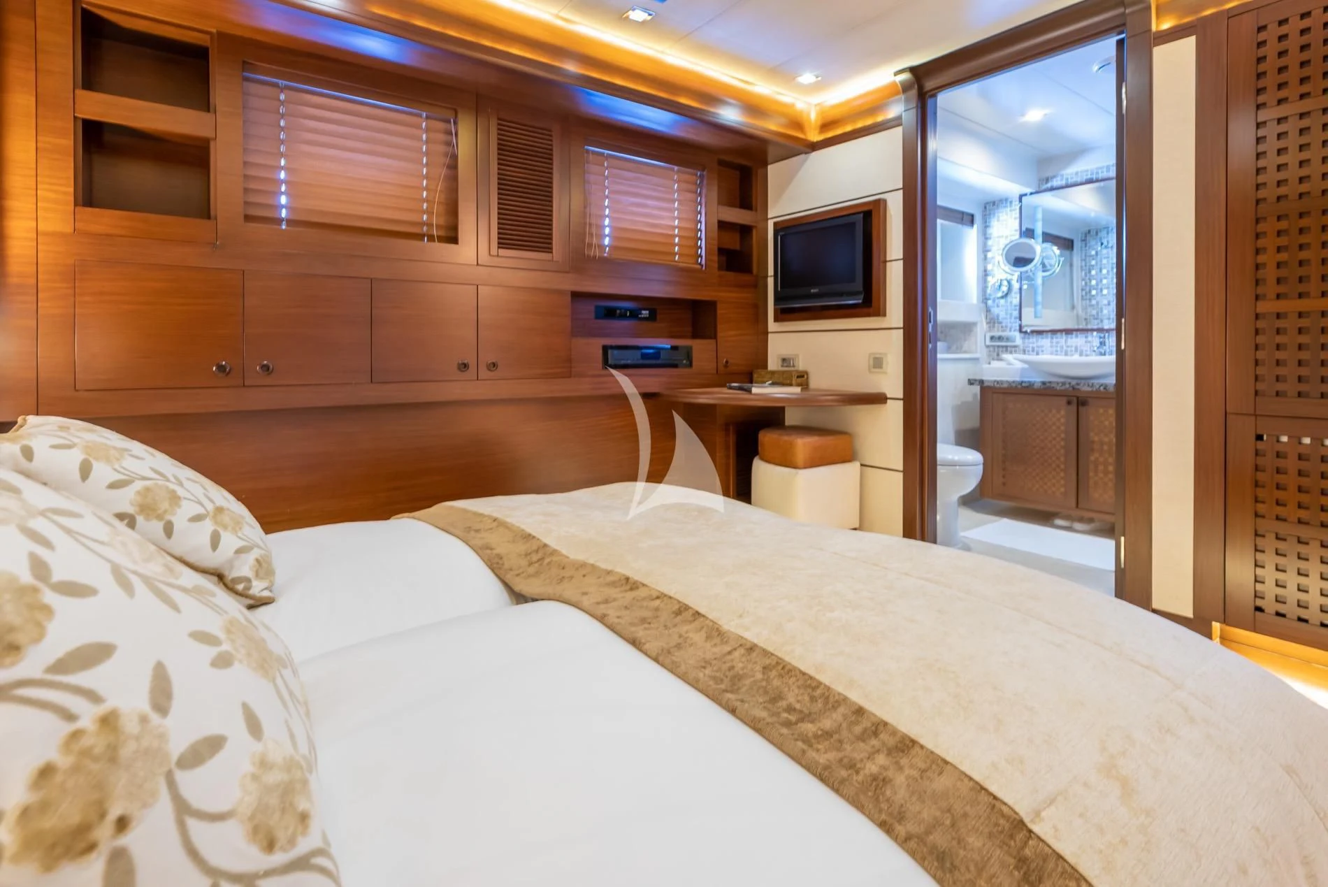 a bedroom with a bed and a television aboard DAIMA Yacht for Sale