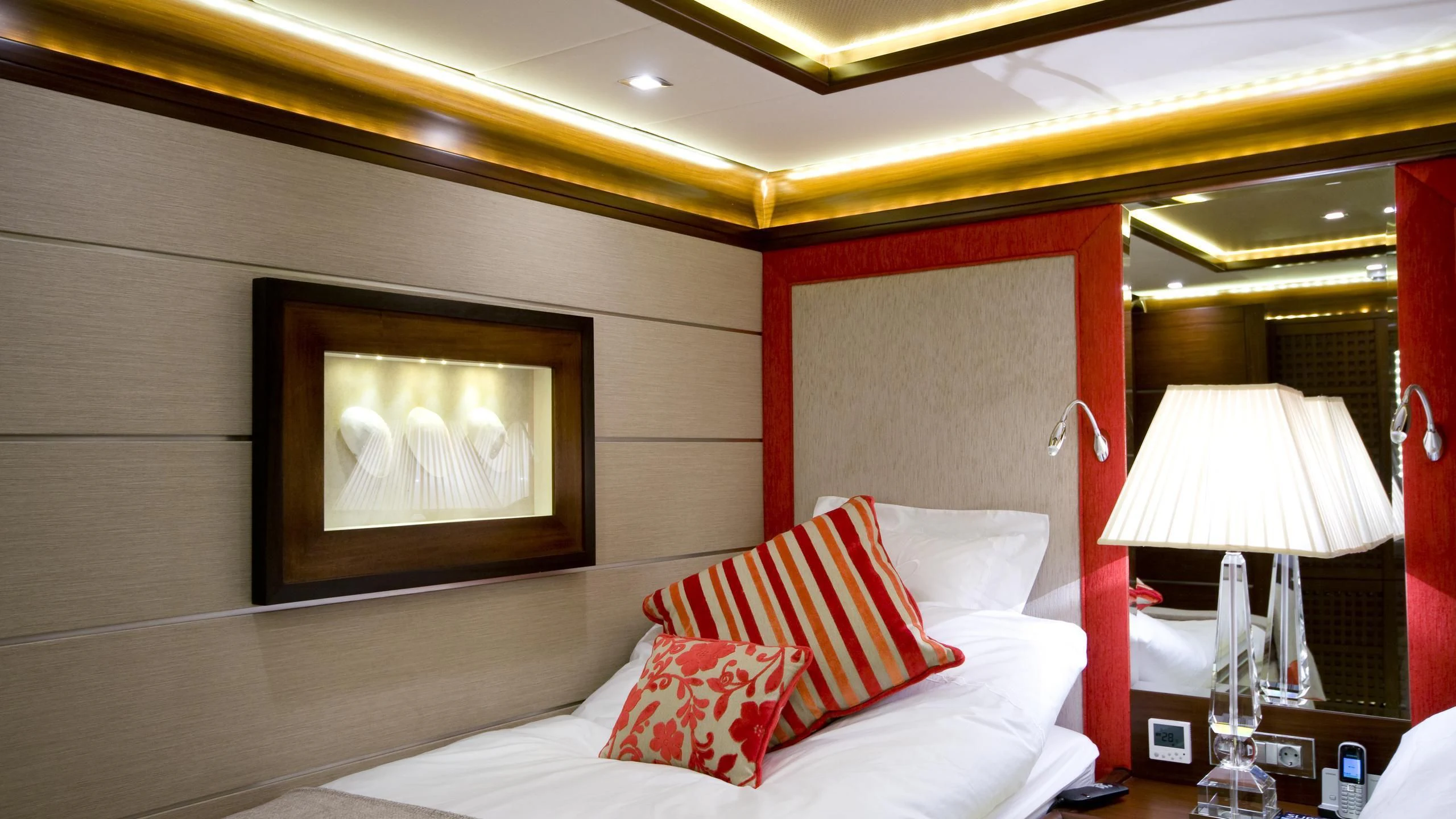 a bed with pillows and a lamp aboard DAIMA Yacht for Sale
