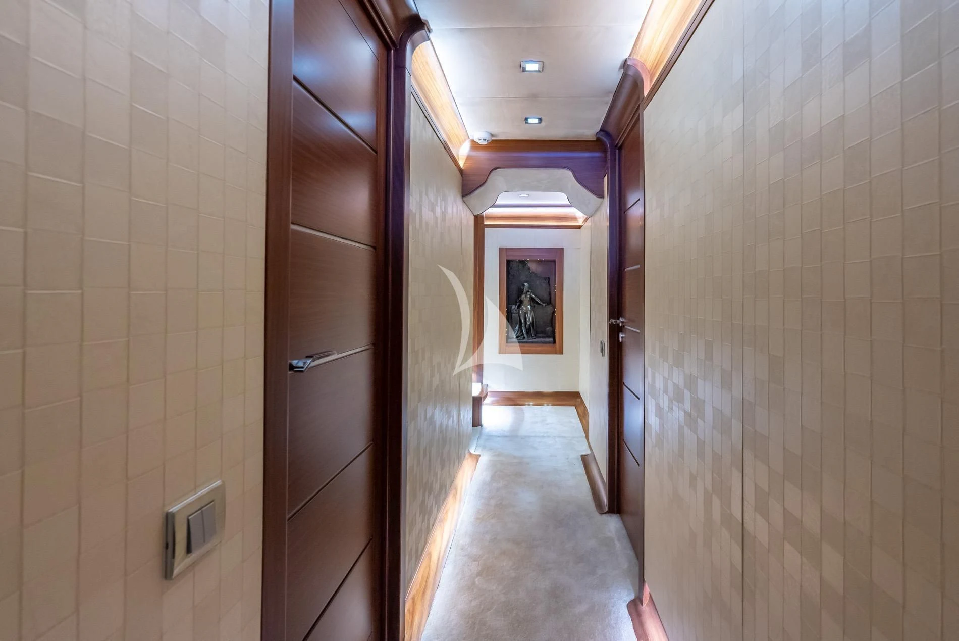 a hallway with a door and a picture on the wall aboard DAIMA Yacht for Sale