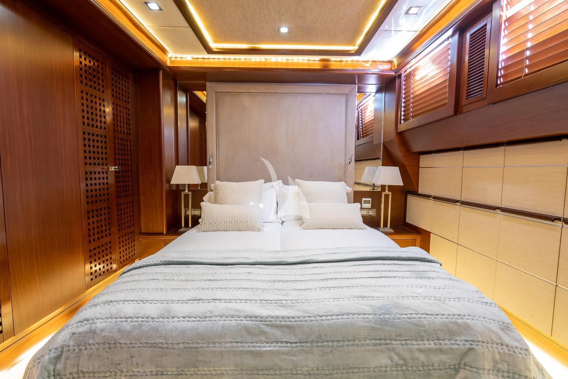 a bed with a blue sheet aboard DAIMA Yacht for Sale