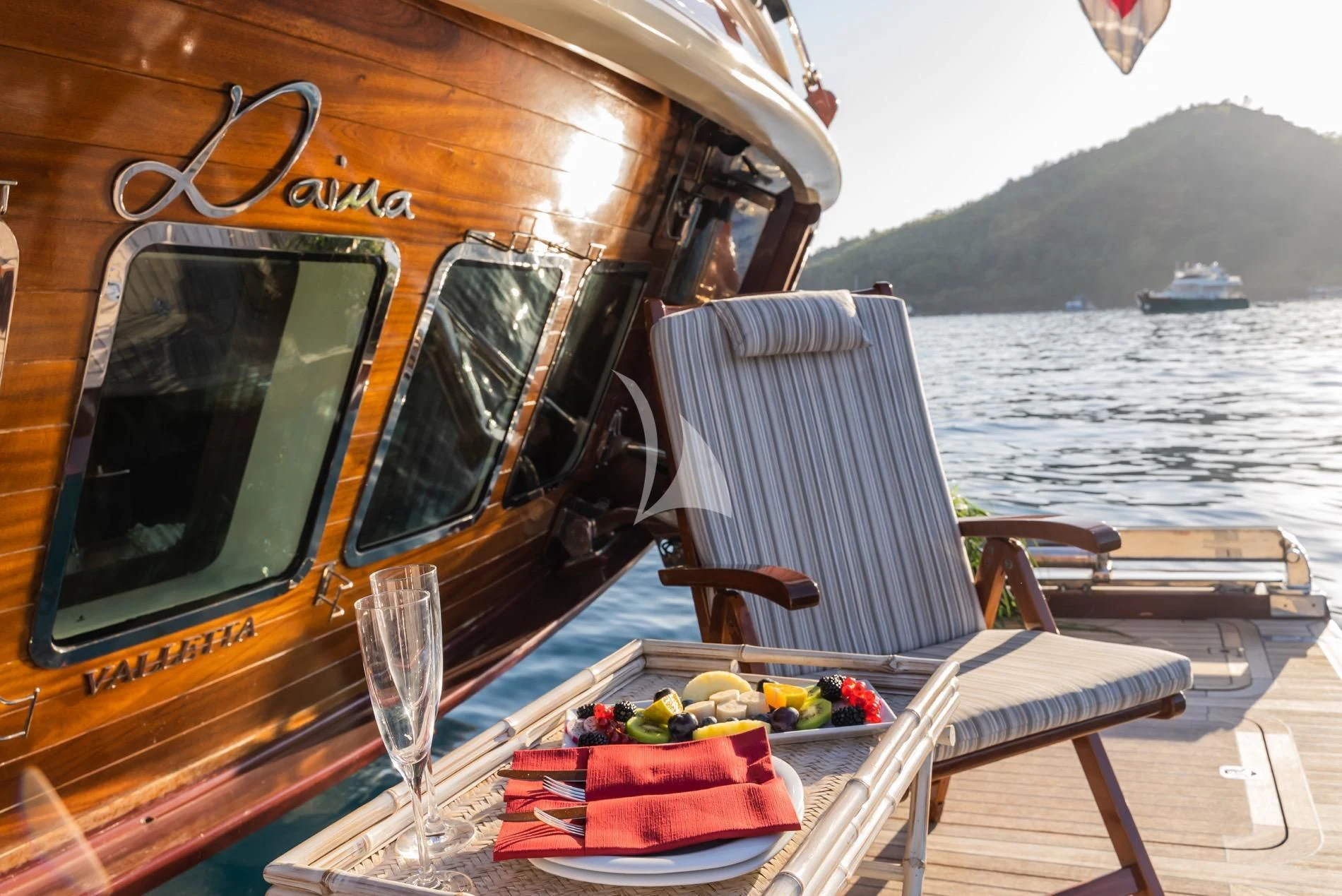 a table with fruits and drinks on it aboard DAIMA Yacht for Sale