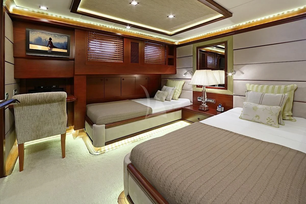a room with a bed and a couch aboard DAIMA Yacht for Sale