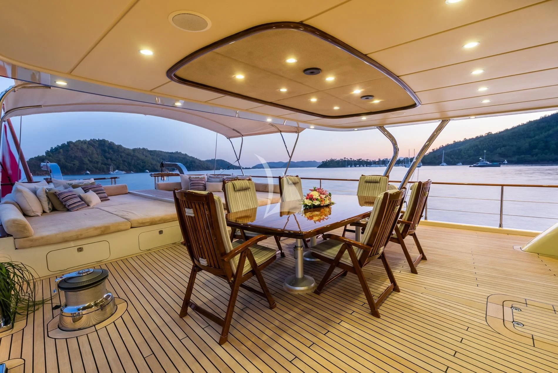 a table and chairs on a deck aboard DAIMA Yacht for Sale