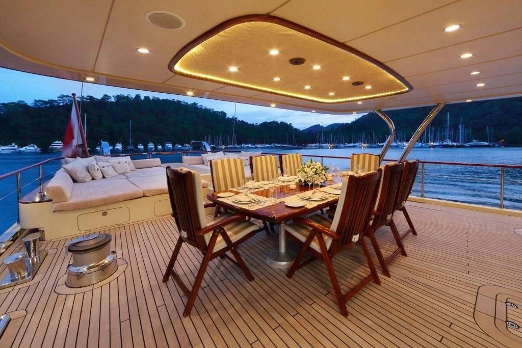 a room with a table and chairs aboard DAIMA Yacht for Sale