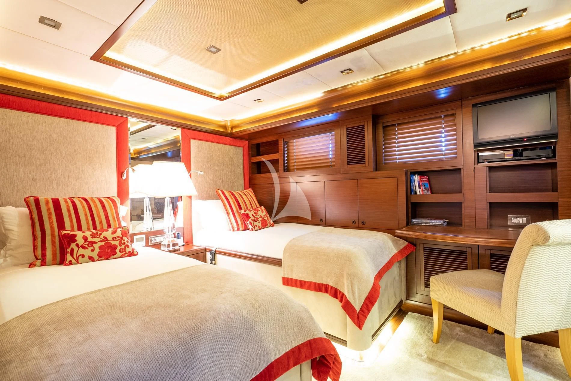 a room with two beds and a tv aboard DAIMA Yacht for Sale