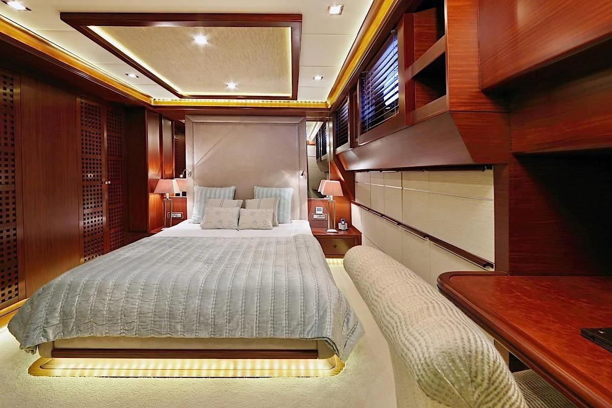 a room with a bed and a window aboard DAIMA Yacht for Sale