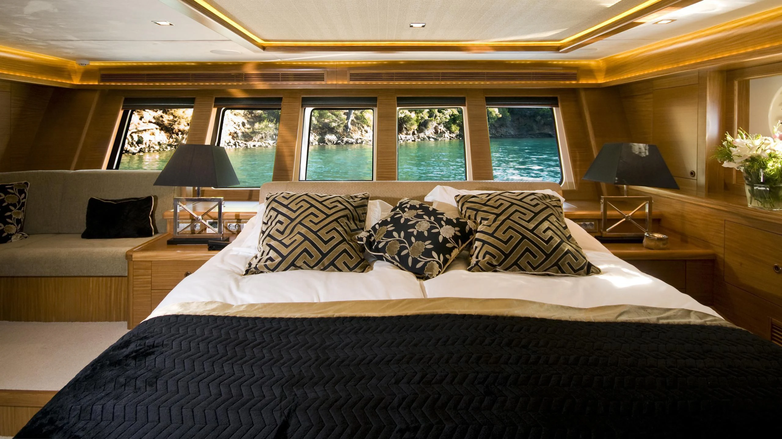 a large bed with pillows aboard DAIMA Yacht for Sale