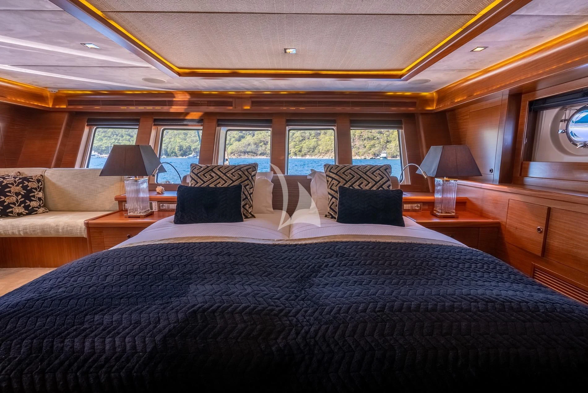 a large bed in a room aboard DAIMA Yacht for Sale