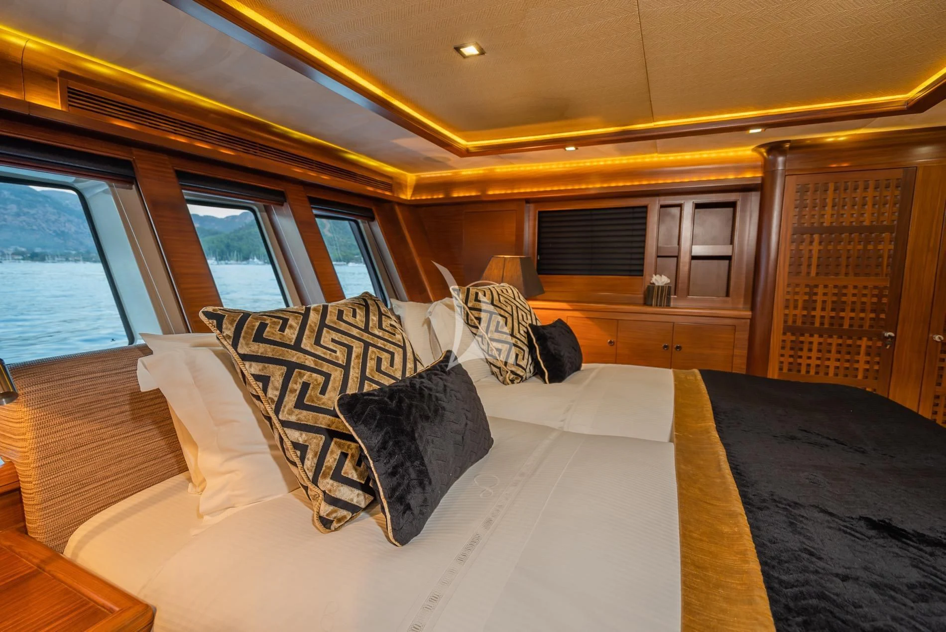 a room with a bed and a window aboard DAIMA Yacht for Sale