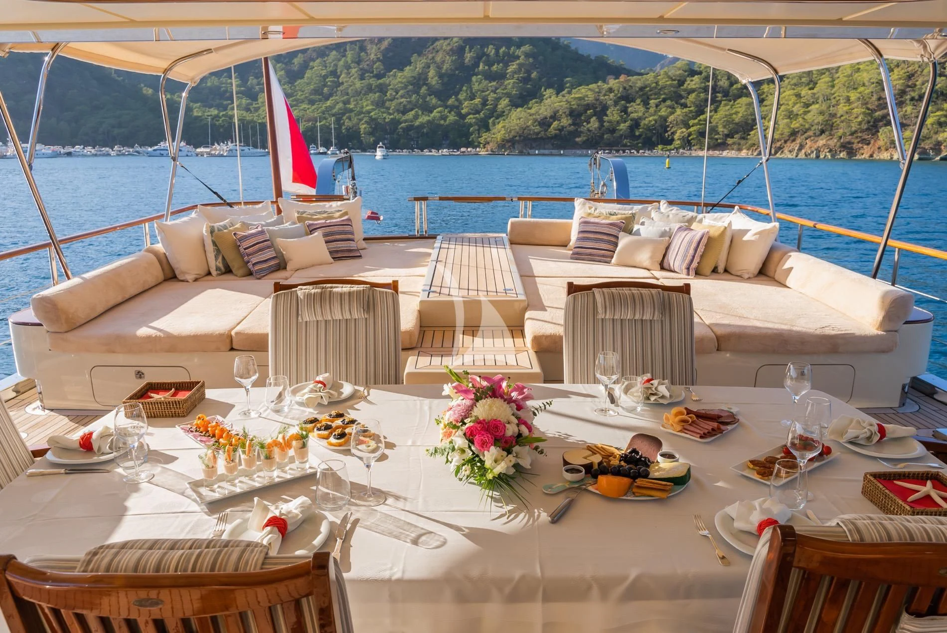 a table with a couch and chairs on it aboard DAIMA Yacht for Sale