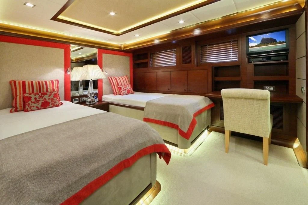 a room with beds and a tv aboard DAIMA Yacht for Sale
