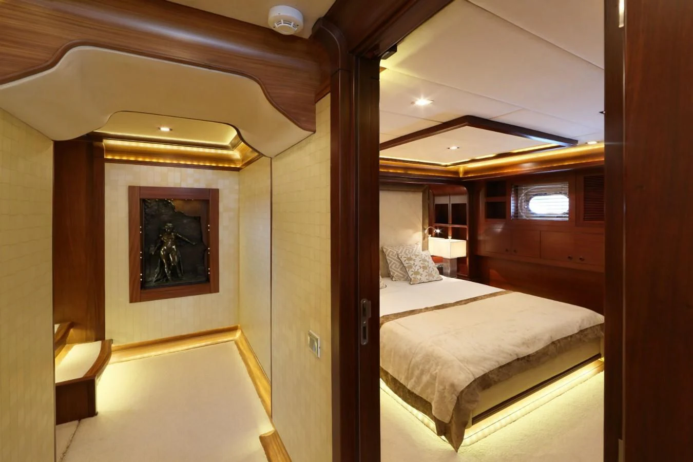 a room with a bed and a painting on the wall aboard DAIMA Yacht for Sale