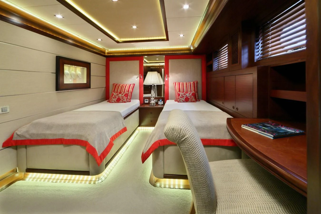 a room with beds and a table aboard DAIMA Yacht for Sale