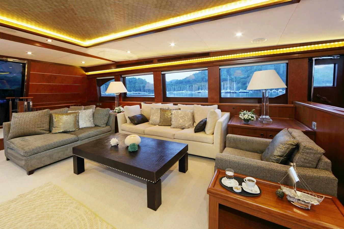 a living room with a couch and a coffee table aboard DAIMA Yacht for Sale