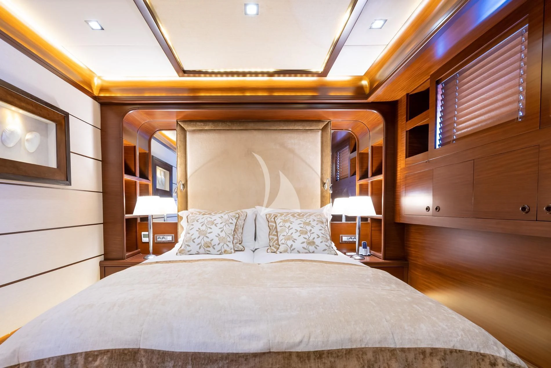 a bed with a white bed spread aboard DAIMA Yacht for Sale