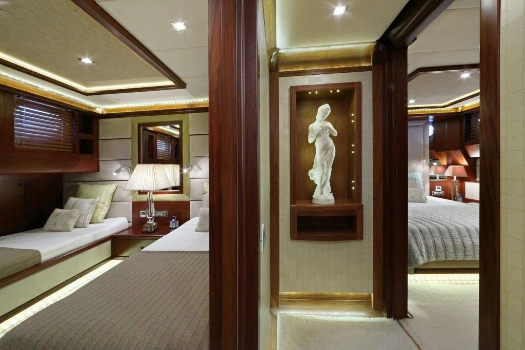 a room with a bed and a painting on the wall aboard DAIMA Yacht for Sale