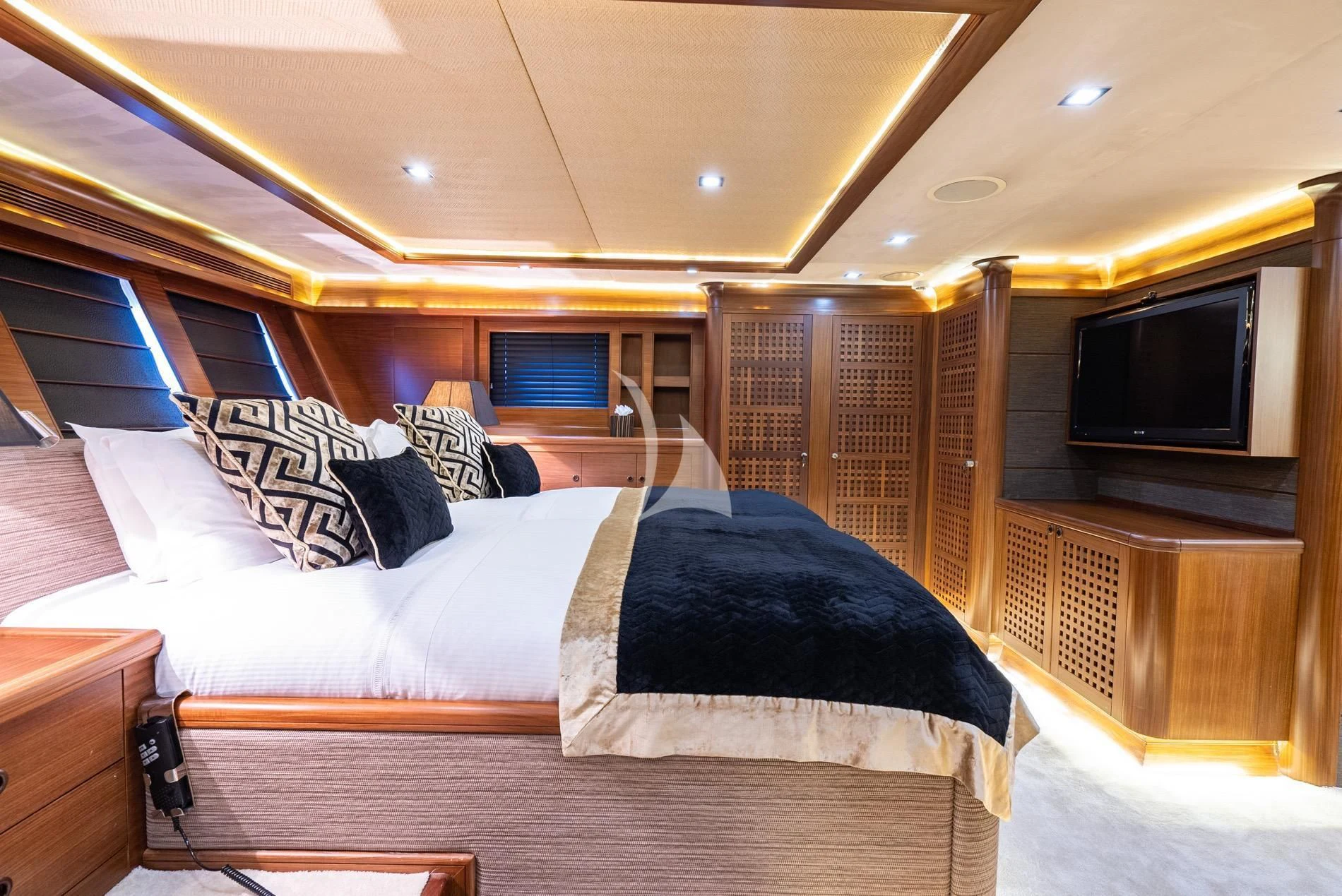 a bed with a blue blanket aboard DAIMA Yacht for Sale