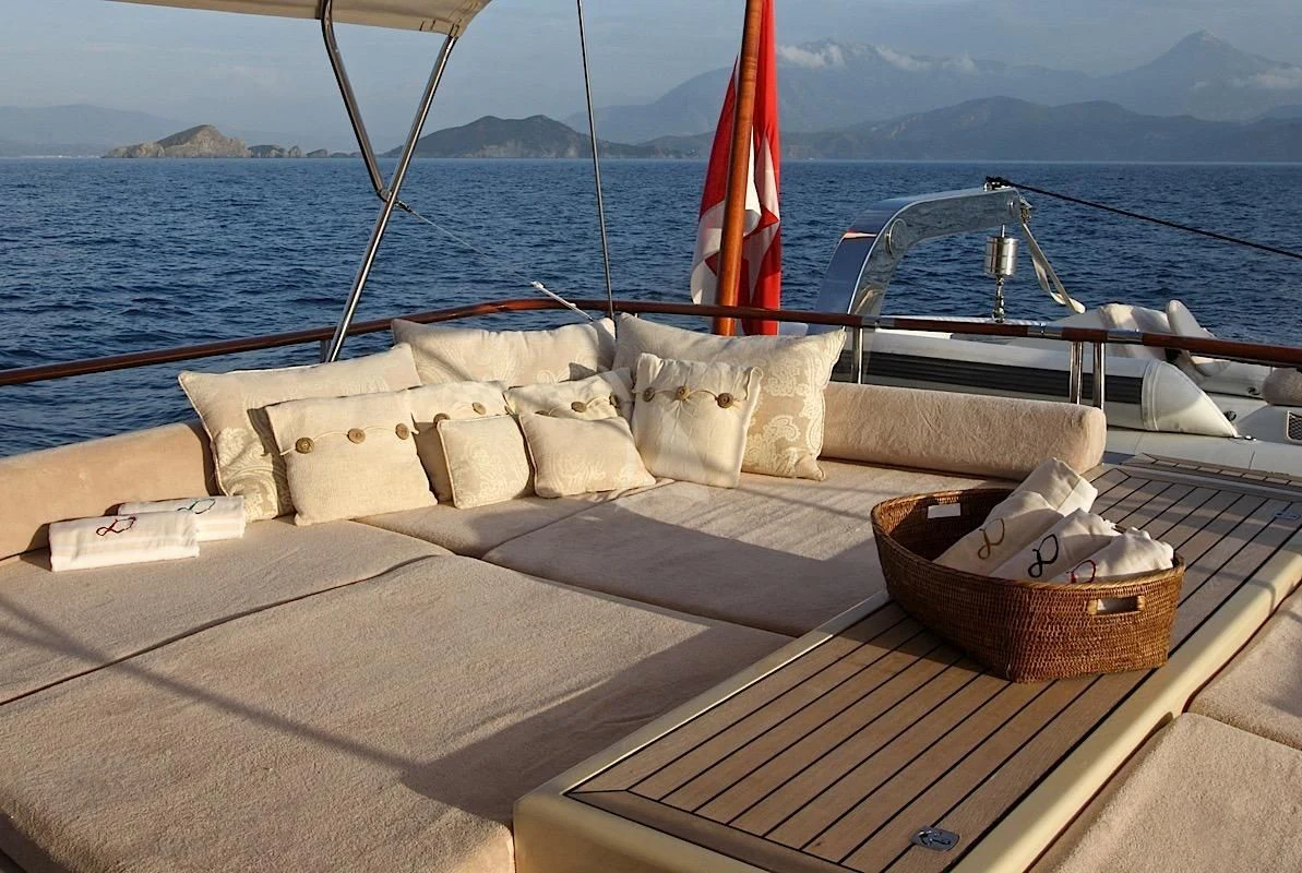 a boat with pillows on the deck aboard DAIMA Yacht for Sale