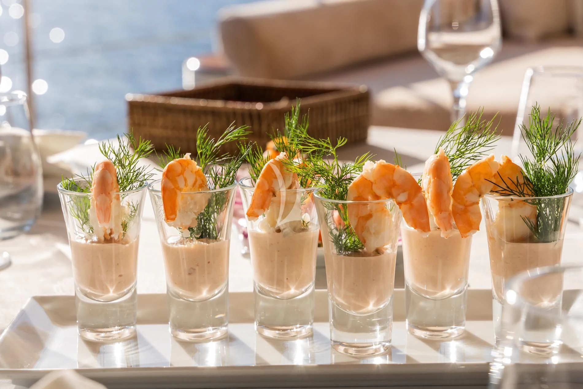 a table with many glasses of champagne and flowers aboard DAIMA Yacht for Sale