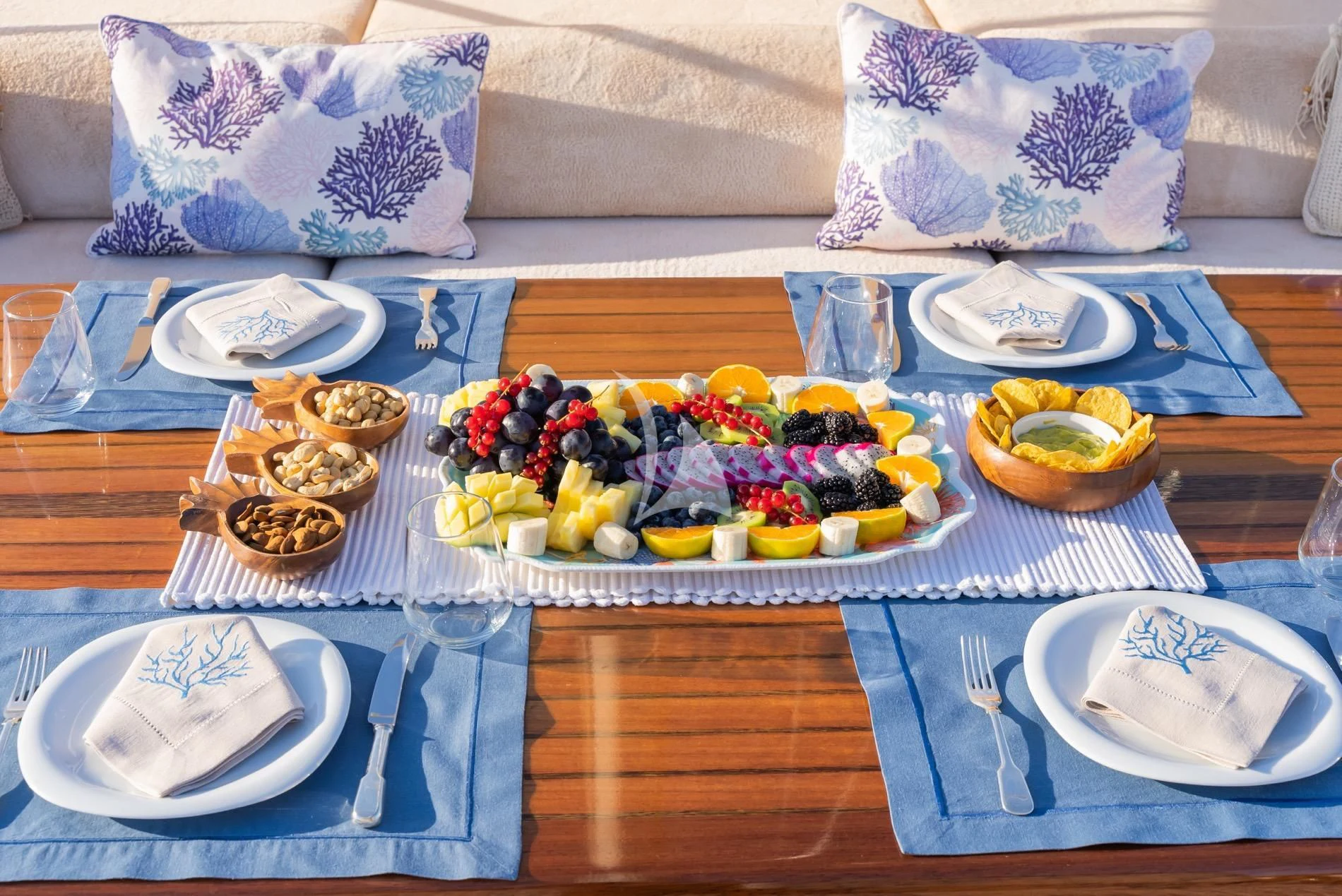 a table with plates and food on it aboard DAIMA Yacht for Sale