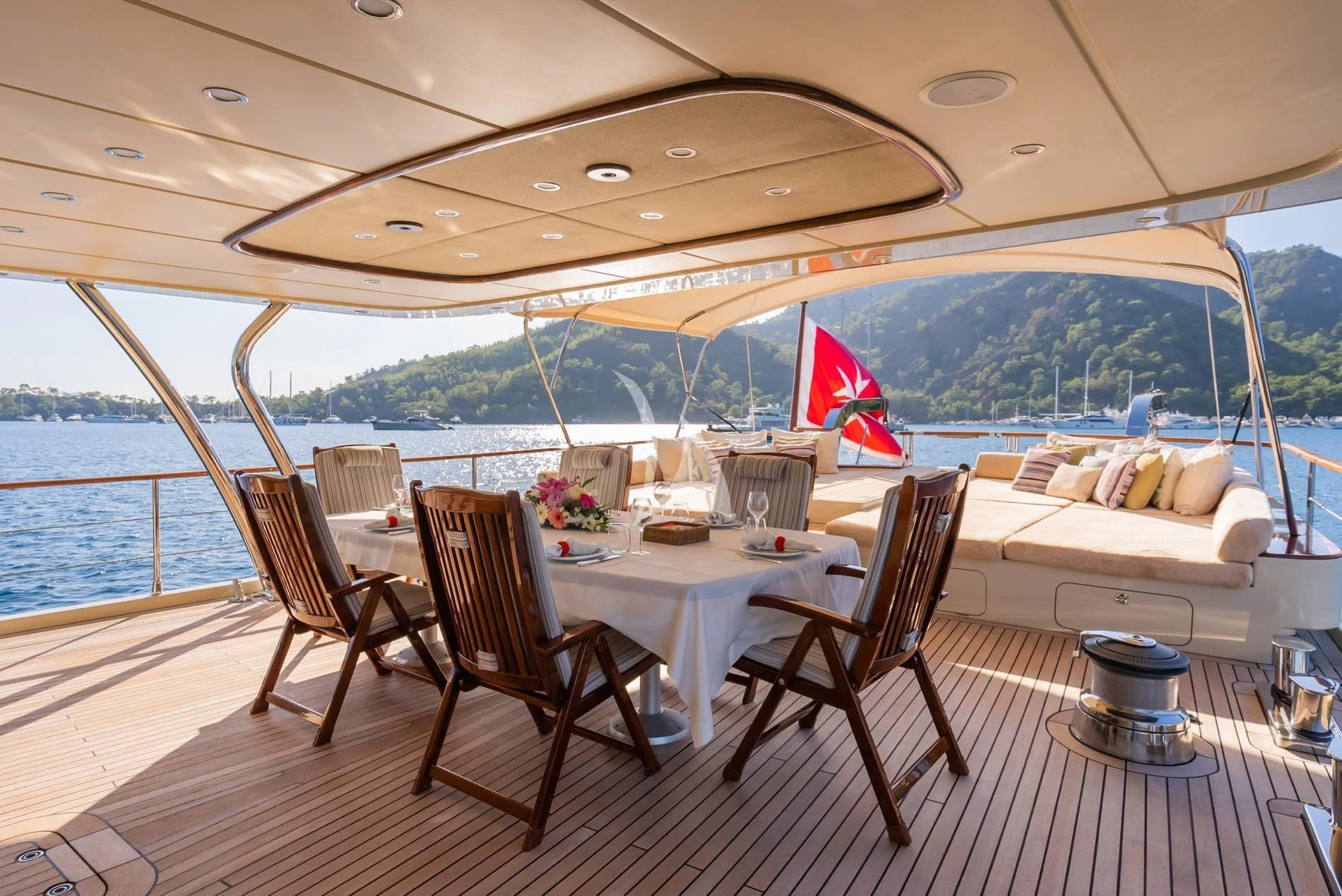 a table and chairs on a deck aboard DAIMA Yacht for Sale