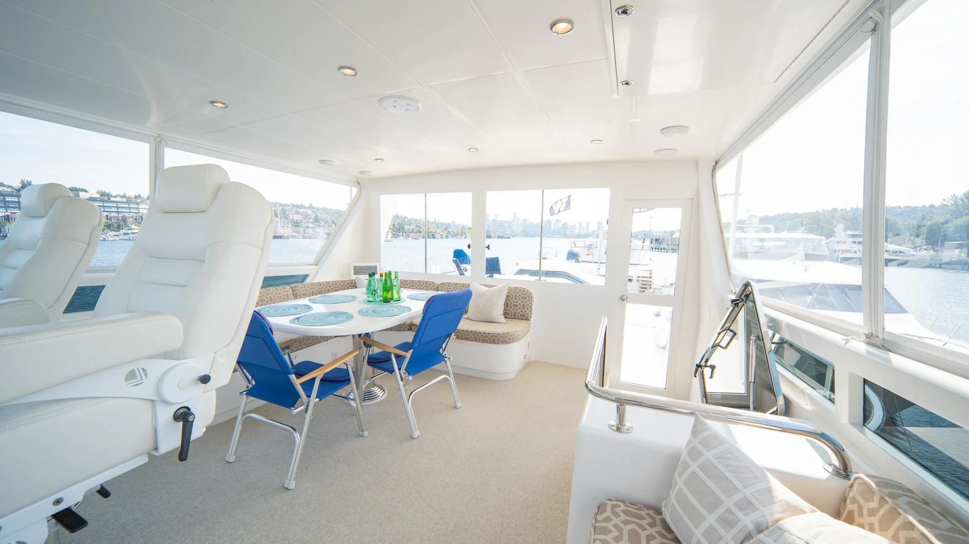 a room with a table chairs and a large window aboard SEA CZAR Yacht for Sale