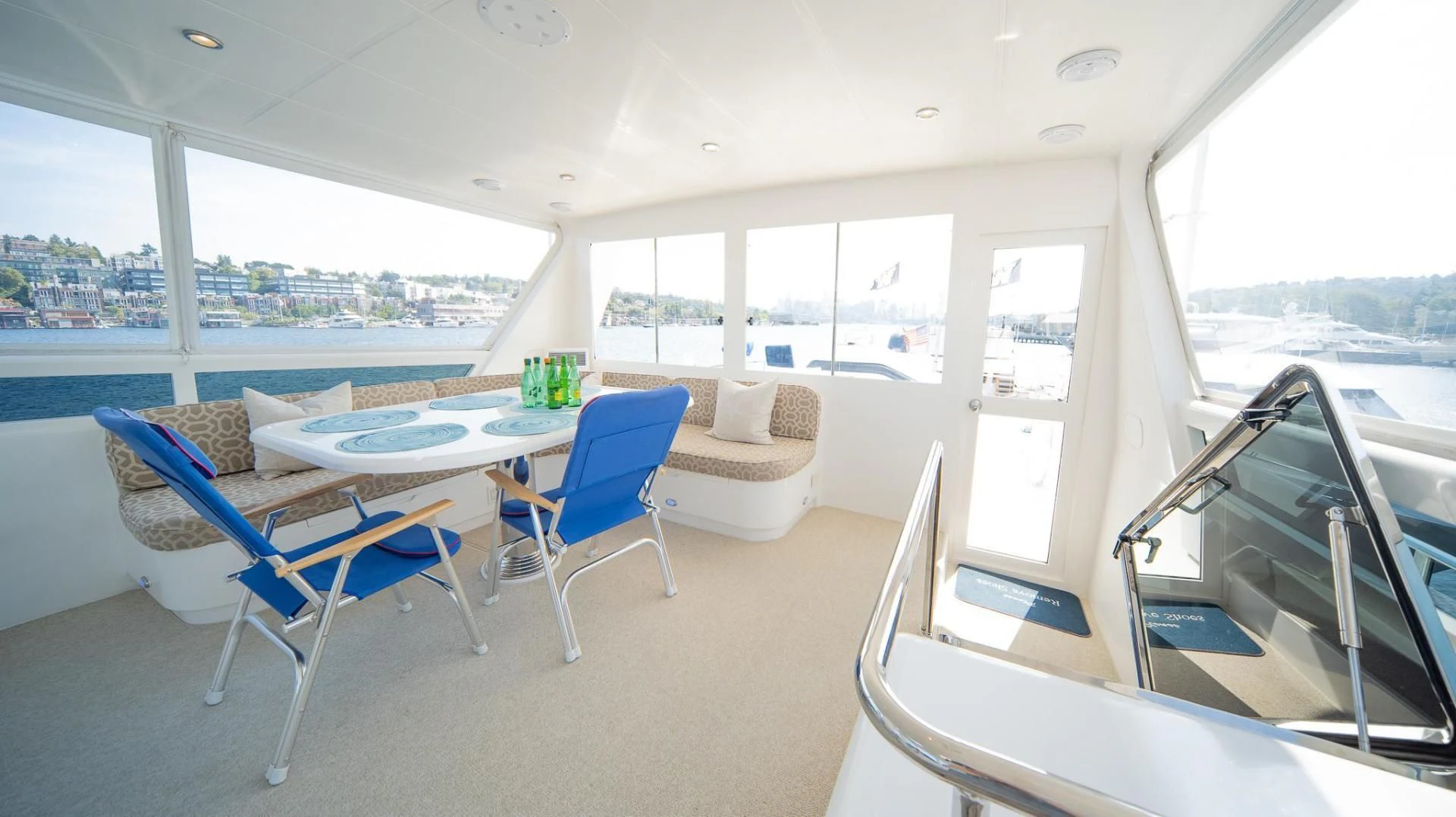 a room with a table chairs and a large window aboard SEA CZAR Yacht for Sale