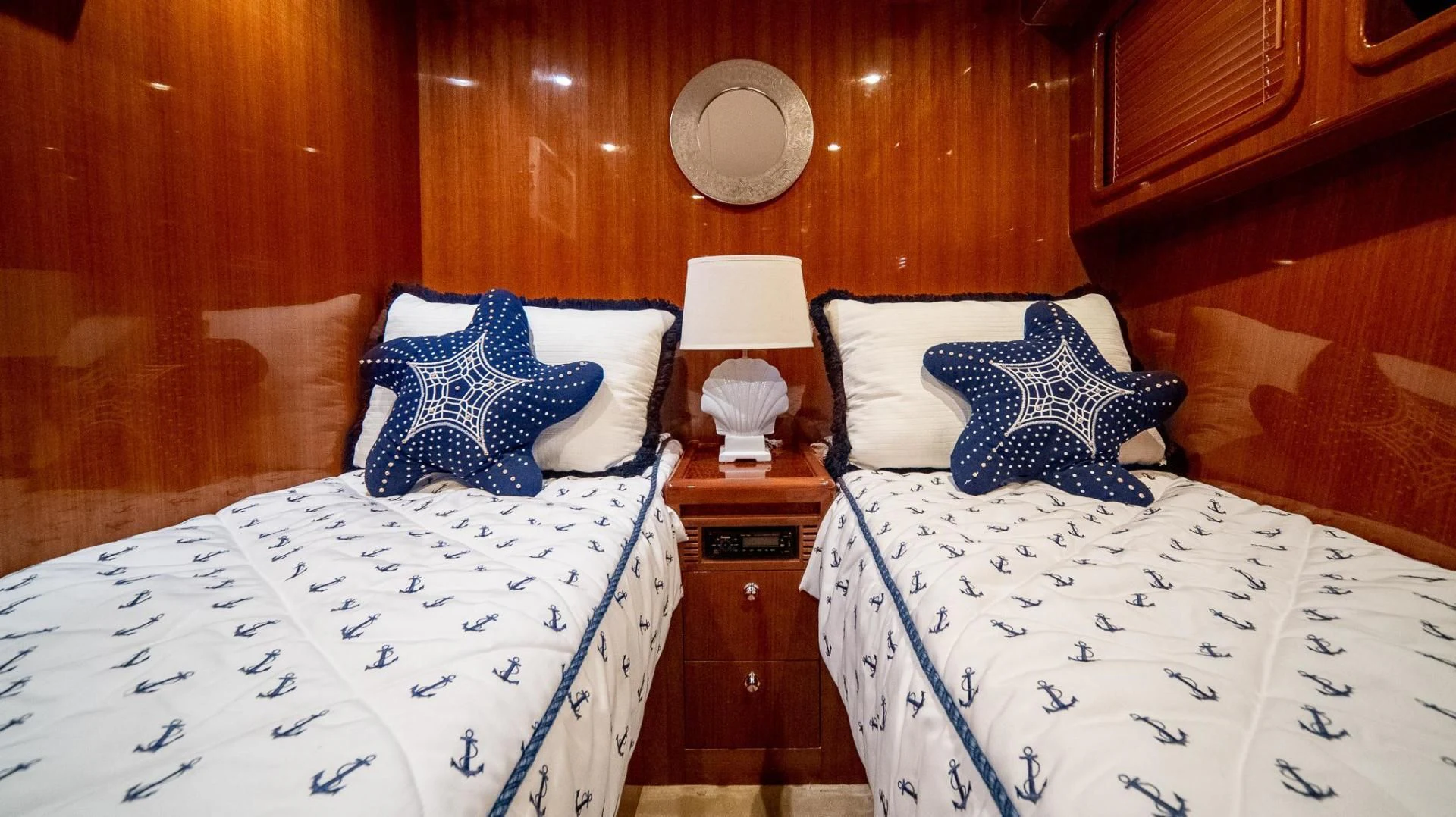 a room with beds and a lamp aboard SEA CZAR Yacht for Sale