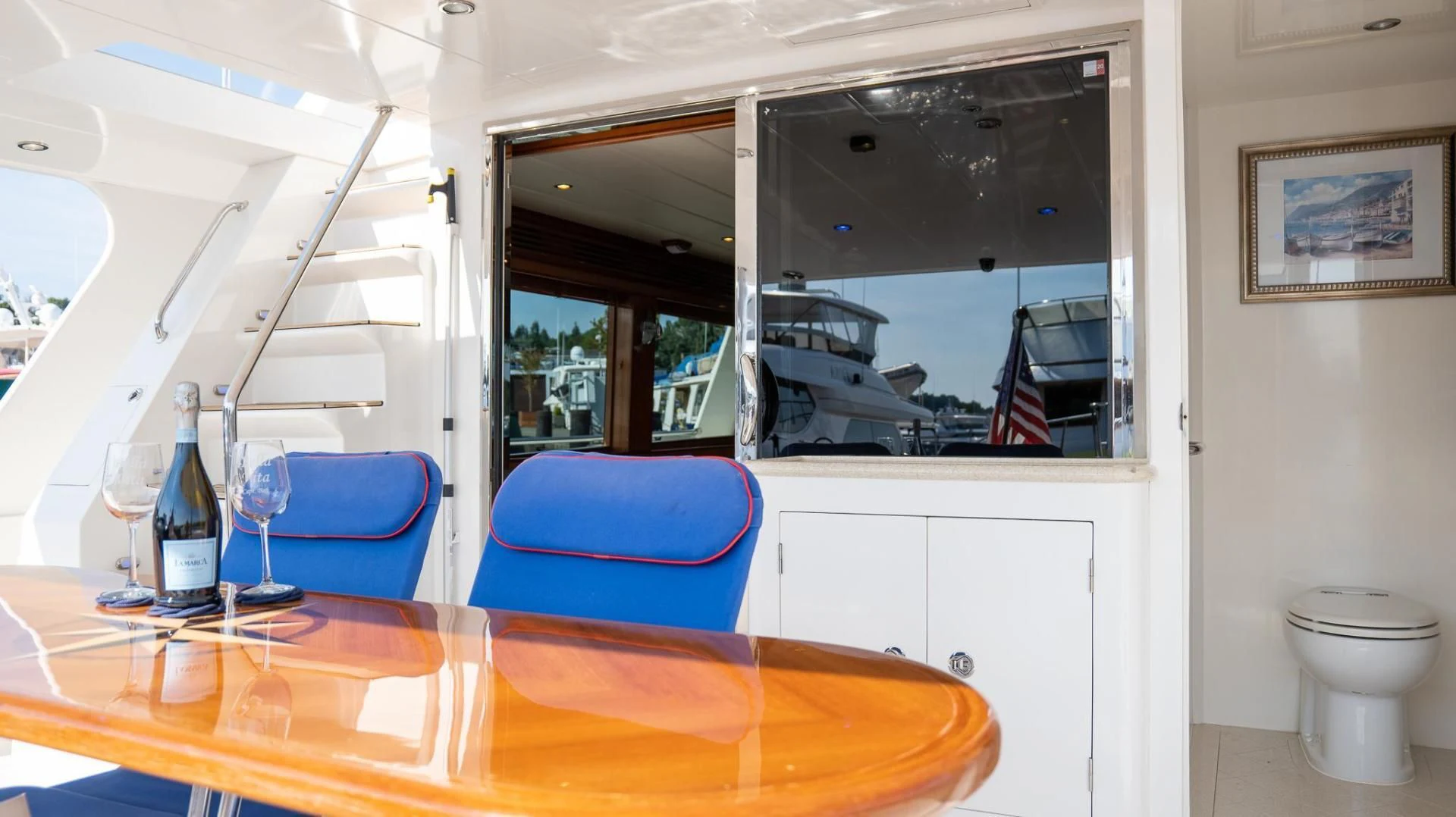 a room with a table and a window with a view of the city aboard SEA CZAR Yacht for Sale