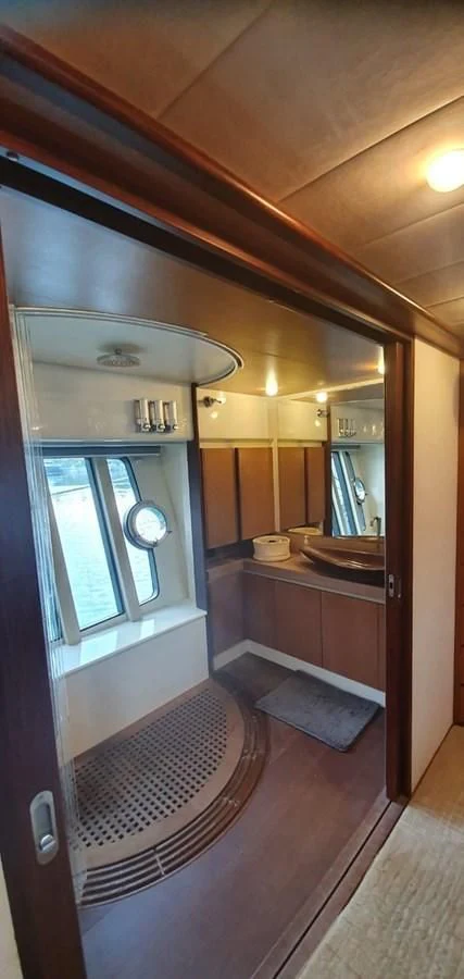 a bathroom with a sink and a mirror aboard SEDROP - 2006 FERRETTI 731 @ PTO. AVENTURAS Yacht for Sale