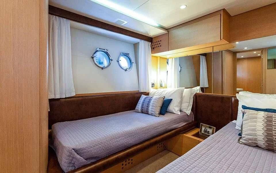 a room with a bed and a mirror aboard SEA PEARL 2 Yacht for Sale