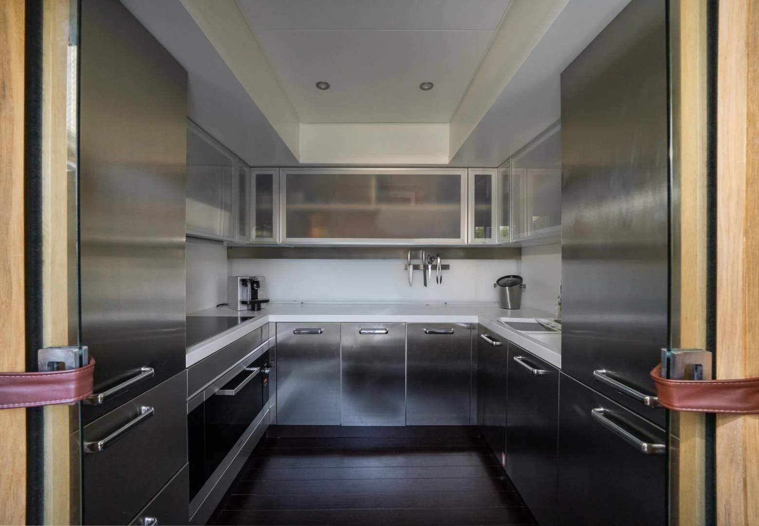 a kitchen with black cabinets aboard SEA PEARL 2 Yacht for Sale