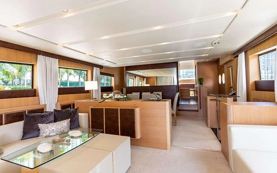 a living room with a kitchen and dining area aboard SEA PEARL 2 Yacht for Sale