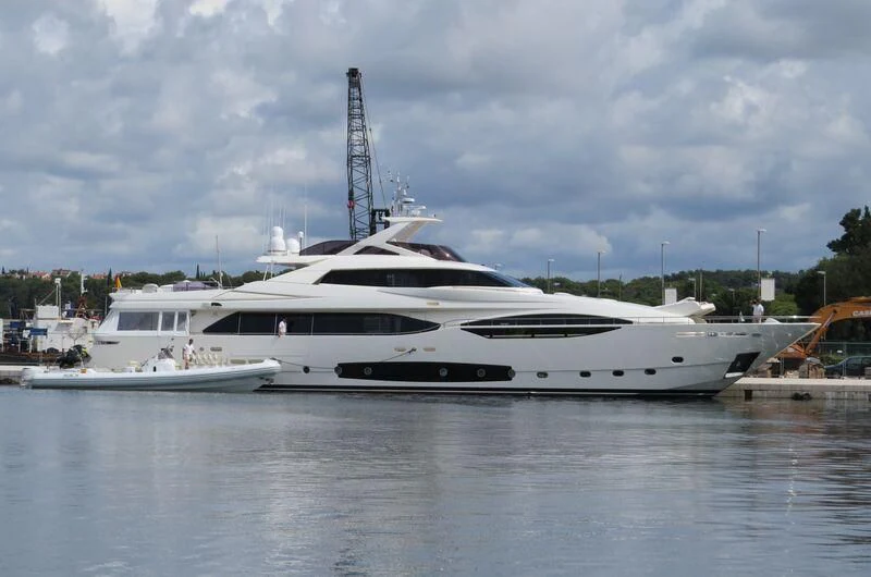 a white yacht in a harbor aboard LAVANDA Yacht for Sale