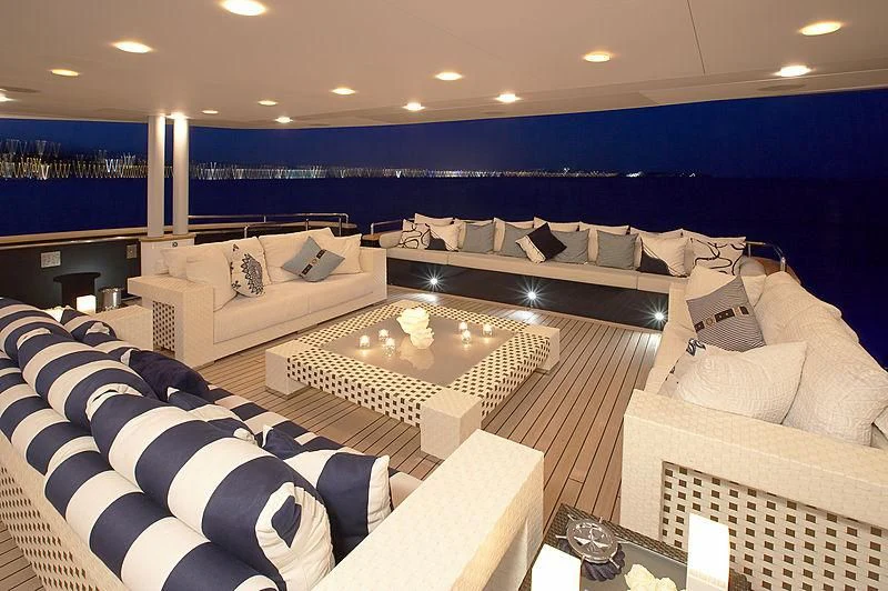 a room with a couch and a table with a large window aboard BURKUT Yacht for Sale