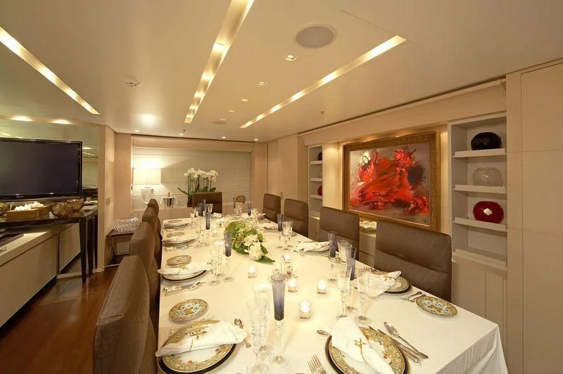 a dining room with a large painting aboard BURKUT Yacht for Sale