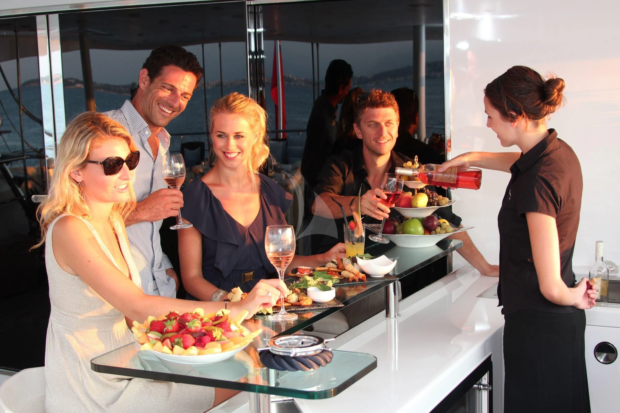 a group of people around a table aboard BURKUT Yacht for Sale
