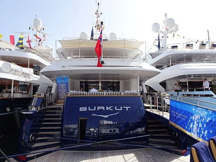a boat with a flag on the deck aboard BURKUT Yacht for Sale