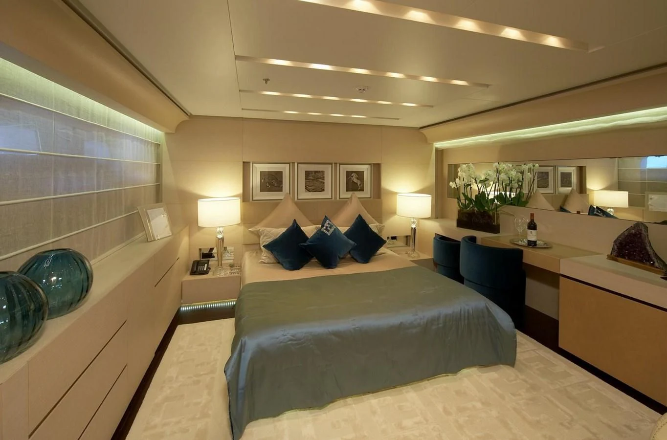 a hotel room with a bed and a desk aboard BURKUT Yacht for Sale