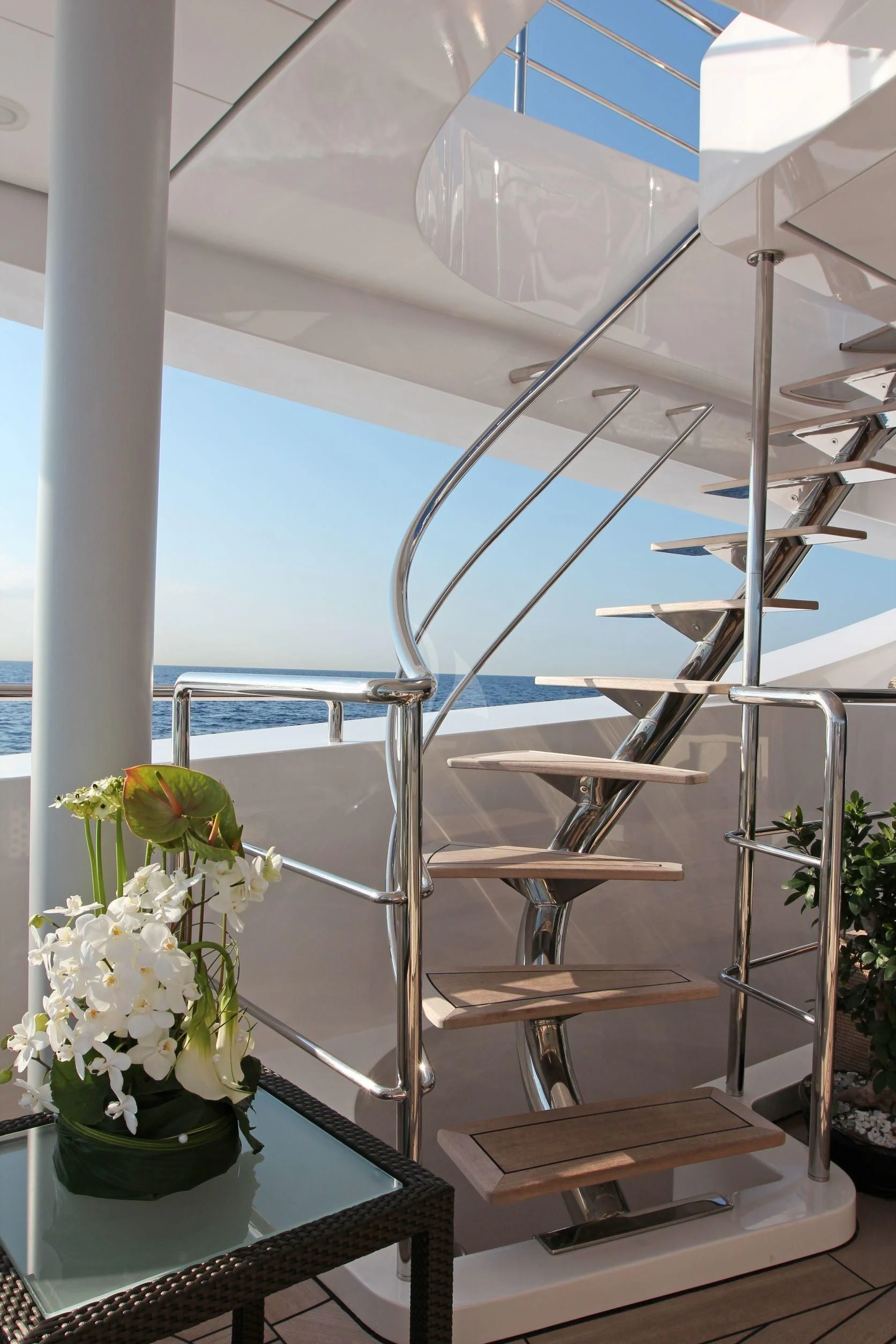 a glass display case with a vase of flowers and a chair aboard BURKUT Yacht for Sale
